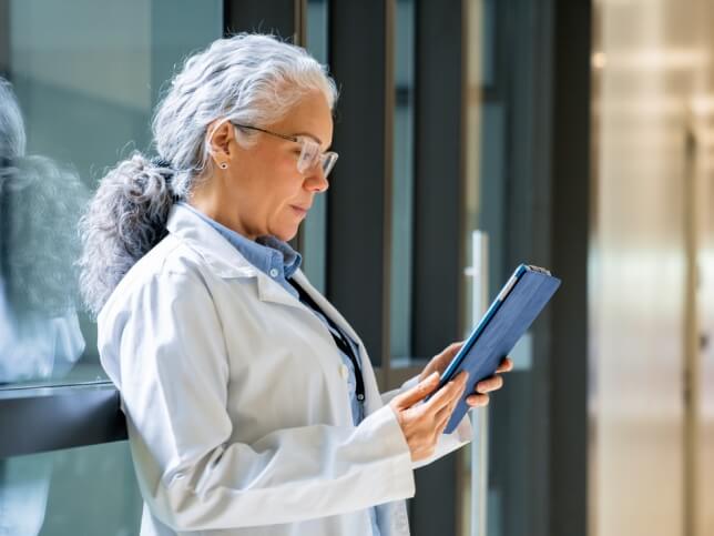 Healthcare professional working on a tablet in medical office 