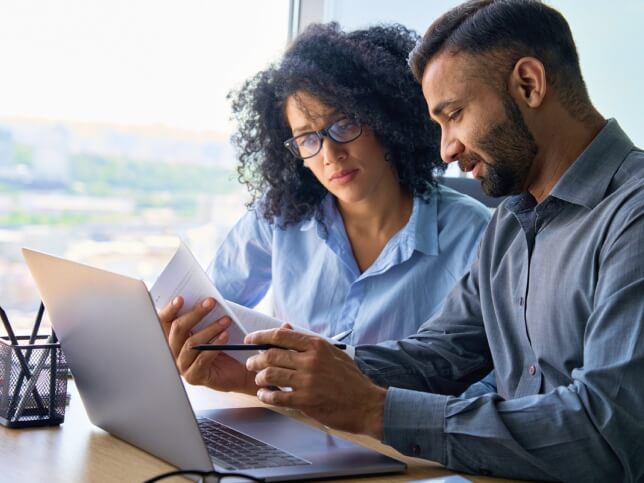 notary with laptop going over documents with a client