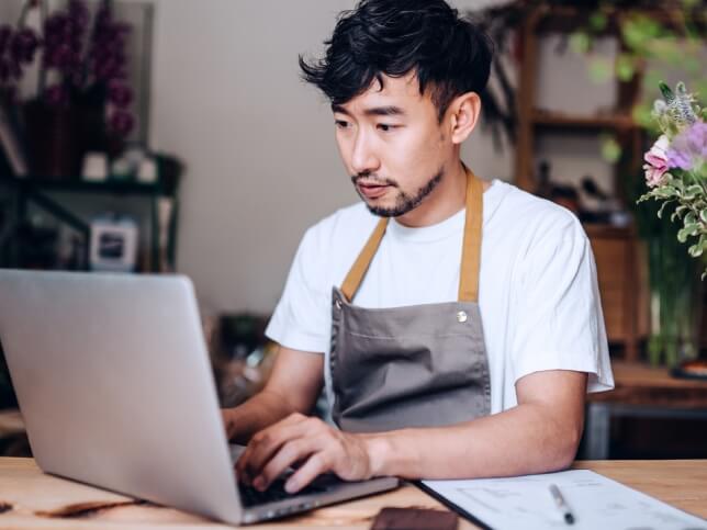 Small business owner working on his laptop 