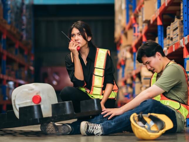 warehouse worker with radio reporting a work injury