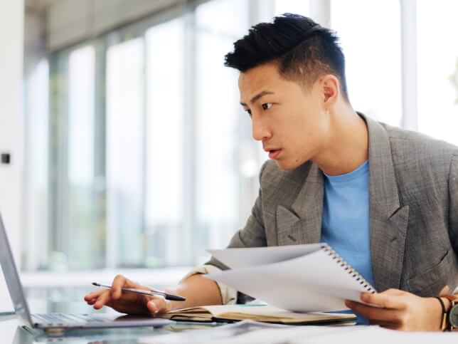 insurance agent checking risks on his laptop and notebook