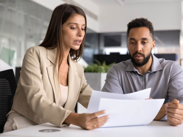 insurance professional going over policies with man at table