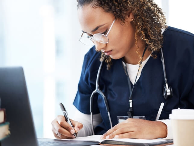 Nurse reviewing her employer's medical malpractice insurance coverage 