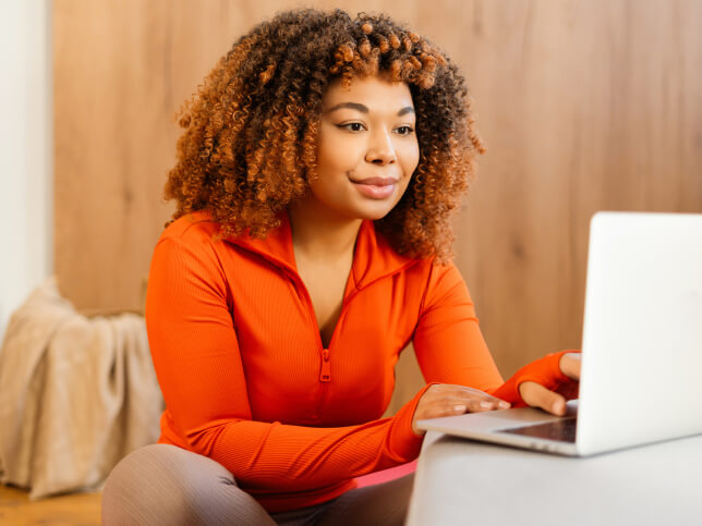 personal trainer searching for insurance on her laptop