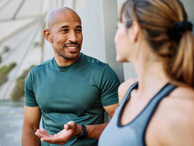personal trainer talking outside with client | insurance for a personal trainer