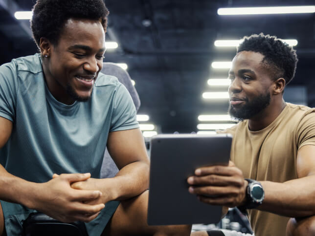 personal trainer working with client in fitness facility
