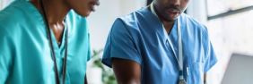 two nurses working on a computer | what is the best malpractice insurance for nurses