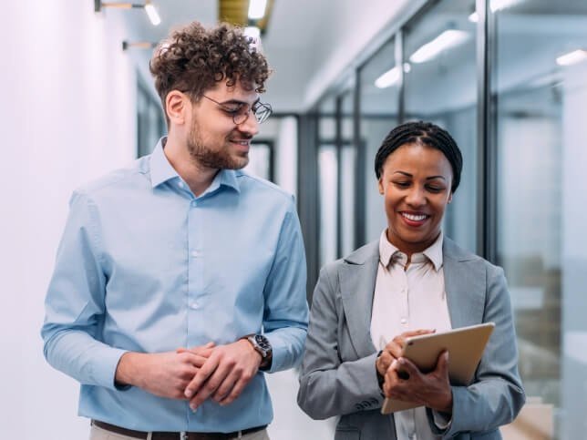 two professionals in a hallway discussing why they need professional liability insurance | Do I need professional liability insurance