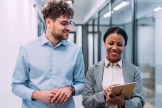 two professionals in a hallway discussing why they need professional liability insurance | Do I need professional liability insurance