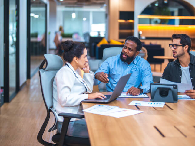 a group of business professionals talking at a table