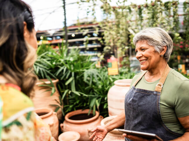 business owner talking with customer in garden center