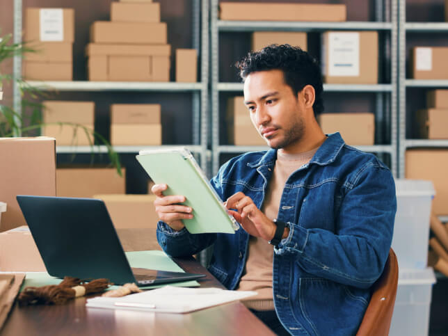 business owner working on tablet in warehouse comprehensive general liability insurance | What is comprehensive liability insurance?