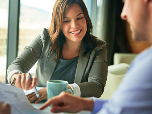 business professional reviewing costs with business owner