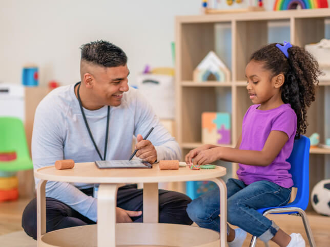 counselor working with child in classroom