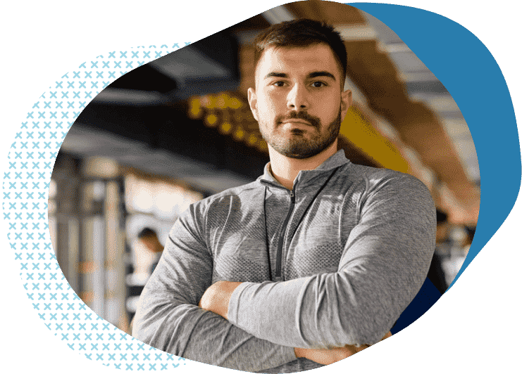 personal trainer in hoody with arms folded learning about affordable liability insurance for personal trainers