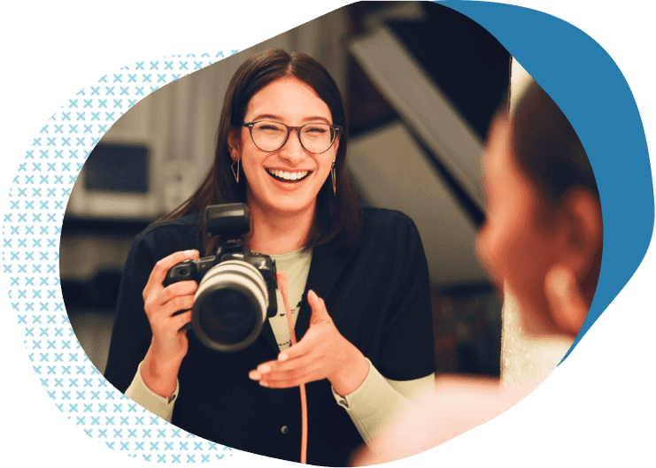 smiling photographer working with client | insurance for photography businesses