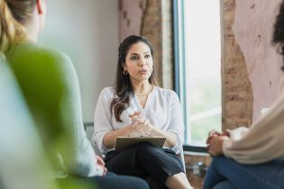 Therapist talking with clients in office | can a therapist be subpoenaed