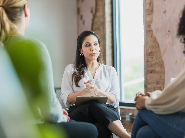 Therapist talking with clients in office | can a therapist be subpoenaed 