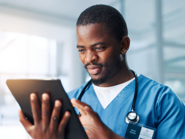 nurse looking at a book telling him how to buy medical malpractice insurance