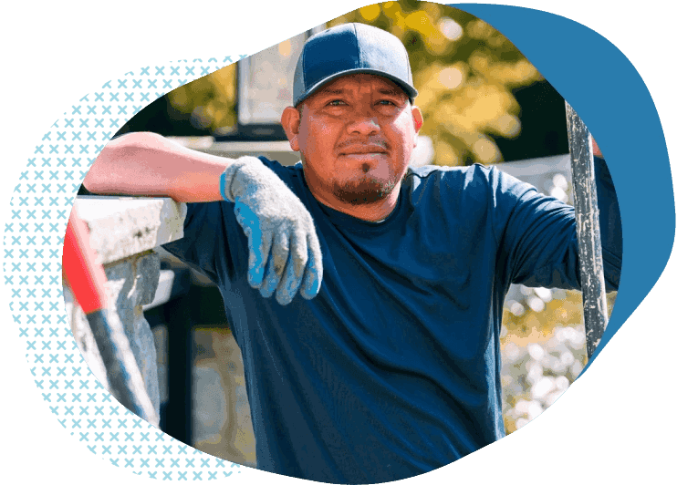 landscaper in gloves and hat buying lawn care liability insurance