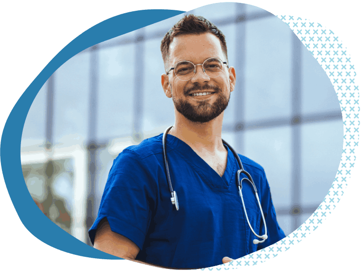 man in scrubs smiling with stethoscope while thinking about liability insurance for healthcare professionals