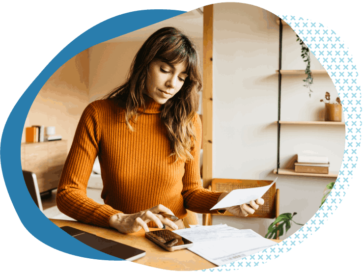 woman in orange turtleneck using calculator in office professional services business insurance