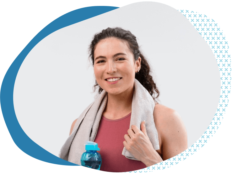 woman with towel on shoulders after working out thinking about fitness liability insurance